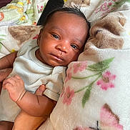 Idris is registered to the contest to win money with this photo: baby, infant, blanket, floral, butterfly, clothing, hand, person, skin, cute, sleepy, soft, comfort, rest, newborn, portrait, indoors, toddler, closeup, warm