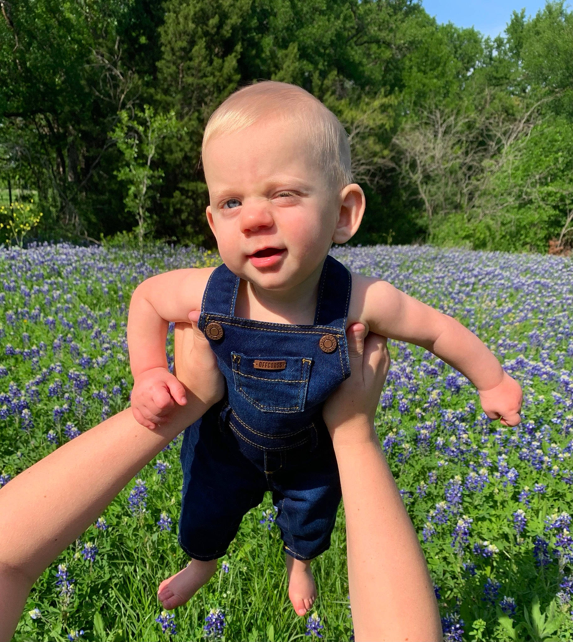 Collin is registered to the contest to win money with this photo: baby_toddler_clothing, child, electric_blue, flower, fun, garden, grass, grass_family, grassland, happy, iris, lawn, leisure, meadow, people_in_nature, person, plant, sky, summer, toddler