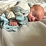 Brayden is registered to the contest to win money with this photo: baby, newborn, sleeping, plush_toy, raccoon, blanket, soft, cozy, infant, cute, child, resting, bed, fabric, hand, face, peaceful, comfort, indoor, small