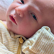 Brayden joined the competition — help win amazing prizes! baby, newborn, close_up, face, sleepy, soft_skin, yellow_stripes, clothing, infant, portrait, cute, child, young, resting, indoors, warm, toddler, baby_clothes, zipper, hand