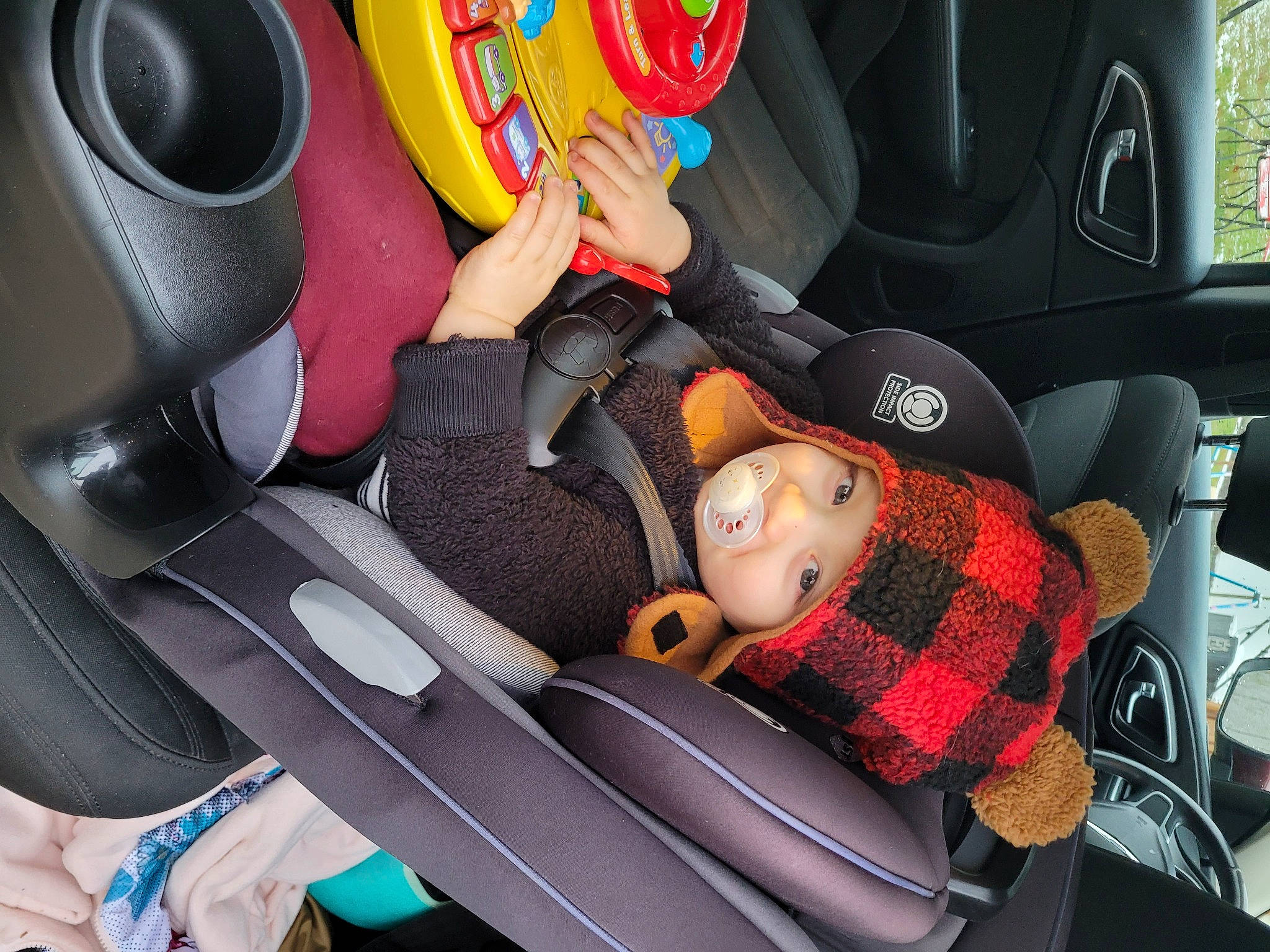 Christopher is registered to the contest to win money with this photo: auto_part, automotive_design, automotive_exterior, automotive_tire, automotive_wheel_system, car, car_seat, car_seat_cover, comfort, head_restraint, headwear, motor_vehicle, person, personal_luxury_car, plant, product, seat_belt, steering_part, steering_wheel, toy