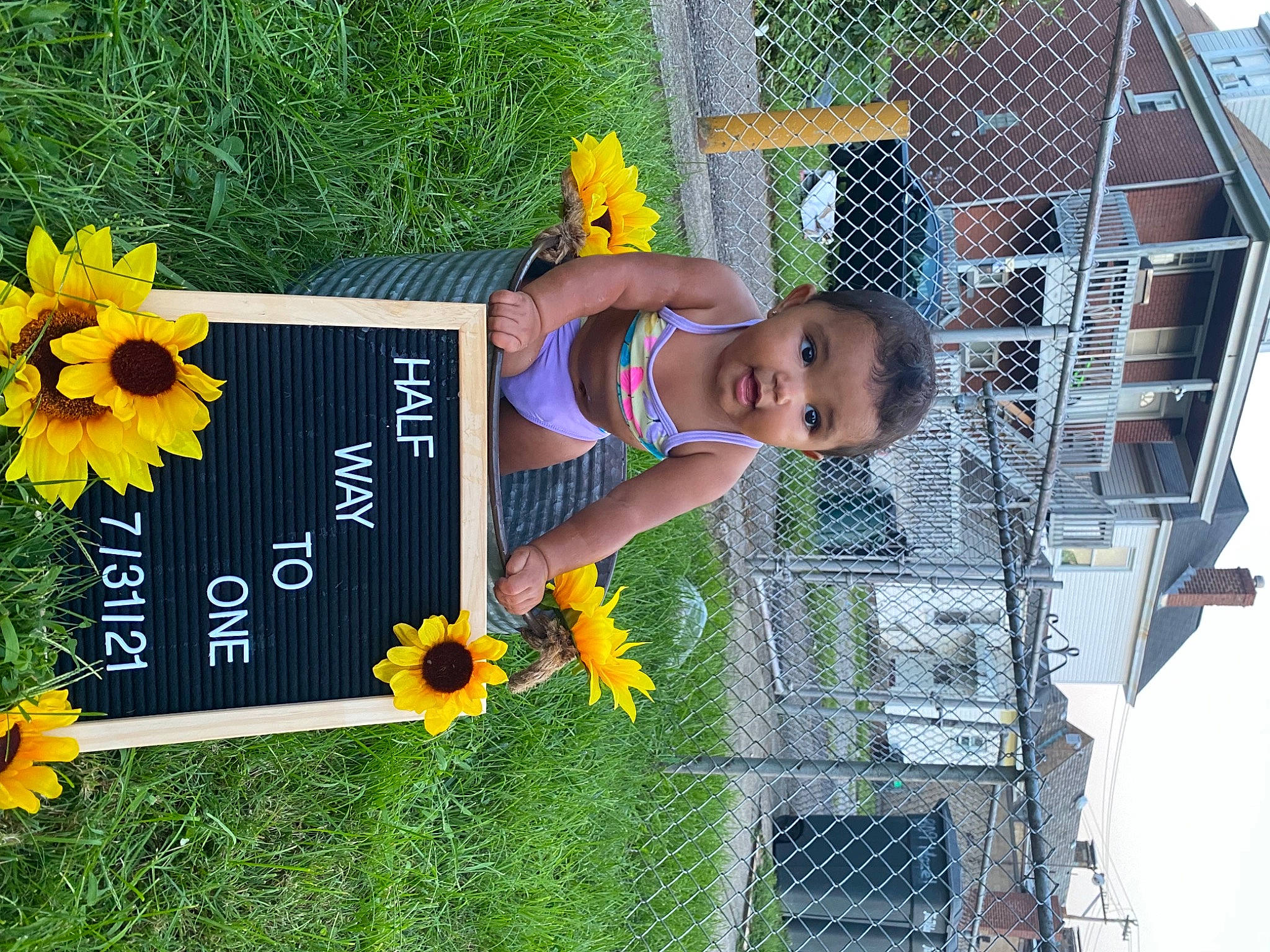 Dalylah Lahrey joined the competition — help win amazing prizes! annual_plant, baby_toddler_clothing, beauty, fence, flower, fun, grass, green, happy, leisure, mesh, people_in_nature, person, petal, plant, sky, smile, sunglasses, t_shirt, toddler