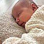 baby, newborn, sleeping, blanket, knit_blanket, sherpa_blanket, face, cheek, ear, eyelashes, peaceful, indoors, closeup, portrait, soft_texture, snuggling, resting, cozy, infant, bedding