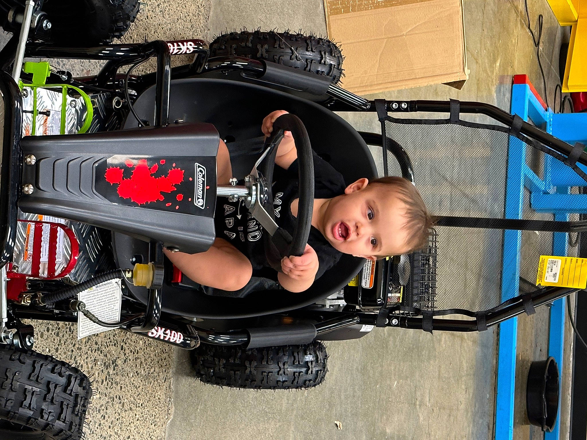 Karson is registered to the contest to win money with this photo: auto_part, automotive_design, automotive_exterior, automotive_lighting, automotive_tire, automotive_wheel_system, bumper, fender, hood, machine, motor_vehicle, person, rim, rolling, tire, toddler, transport, vehicle, vehicle_door, wheel