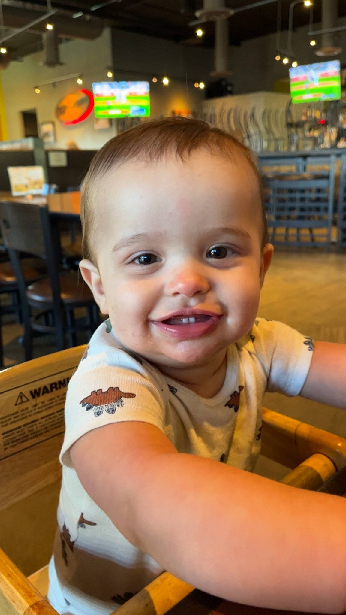 Karson is registered to the contest to win money with this photo: baby, chair, cheek, child, chin, eyebrow, facial_expression, forehead, fun, happy, iris, joy, leisure, nose, person, sitting, skin, smile, standing, t_shirt