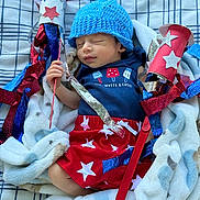 Sunny joined the competition — help win amazing prizes! baby, blanket, bodypart, bonnet, cap, clothing, costume, couch, dress, face, furniture, glove, hat, head, newborn, person, photography, portrait, quilt, sleeping