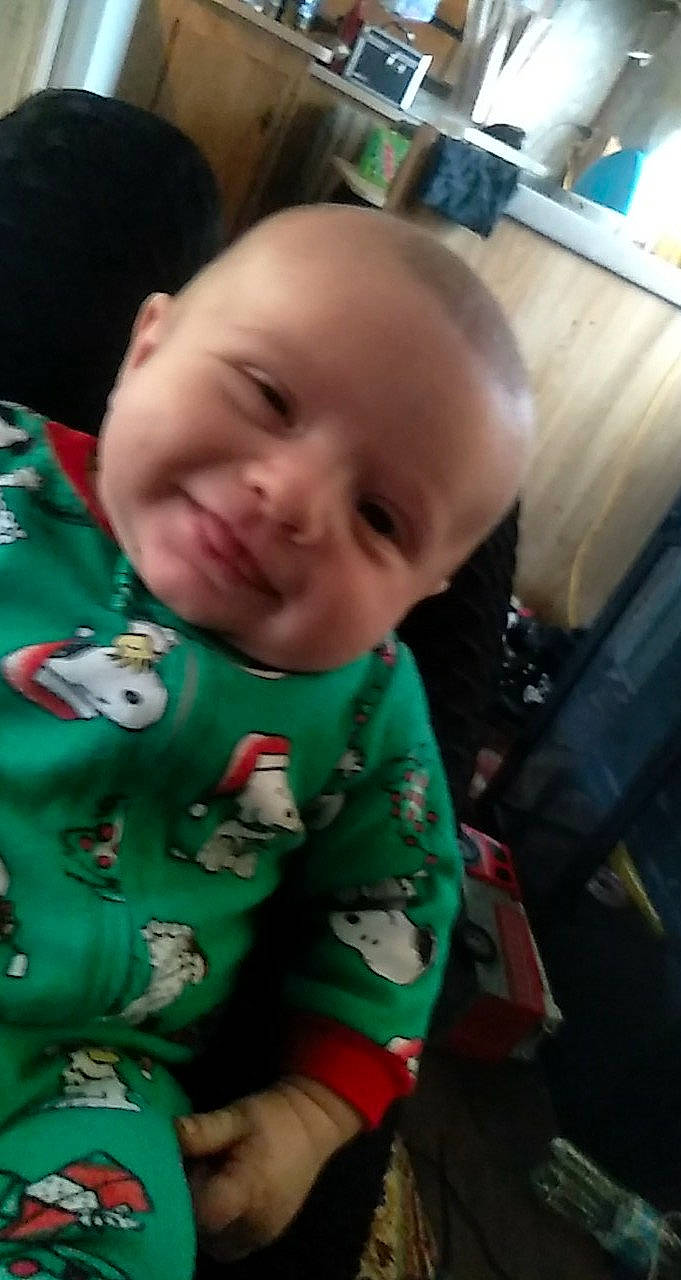 Holtyn is registered to the contest to win money with this photo: baby, baby_toddler_clothing, cheek, child, chin, christmas, event, finger, grass, happy, head, holiday, joy, mouth, nose, person, sitting, skin, sleeve, smile