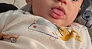 Josiah joined the competition — help win amazing prizes! baby, tongue, onesie, clothing, infant, face, head, skin, expression, indoors, door, person, curious, cute, closeup, child, young, casual, relaxed, portrait