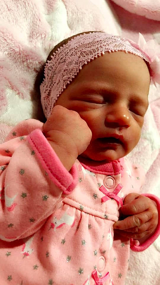 Libby is registered to the contest to win money with this photo: baby, baby_sleeping, bonnet, cheek, child, hand, headgear, lip, mouth, nose, person, pink, skin, smile, textile, toddler