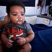 Messiah joined the competition — help win amazing prizes! baby, infant, food, face, clothing, tiger, onesie, hand, sitting, blanket, room, door, clothes, pillow, indoor, cute, child, expression, home, comfort