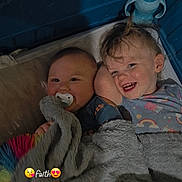 Jayce is registered to the contest to win money with this photo: baby, child, crib, blanket, pacifier, smile, toy, sippy_cup, sleepwear, happy, indoors, bedtime, face, cuddling, toddler, person, hair, expression, cozy, comfort