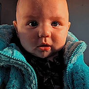 Jayce is registered to the contest to win money with this photo: baby, child, face, eyes, jacket, clothing, drool, indoor, portrait, closeup, curious, cute, infant, young_child, soft_lighting, warm_colors, fuzzy_texture, person, head, expression