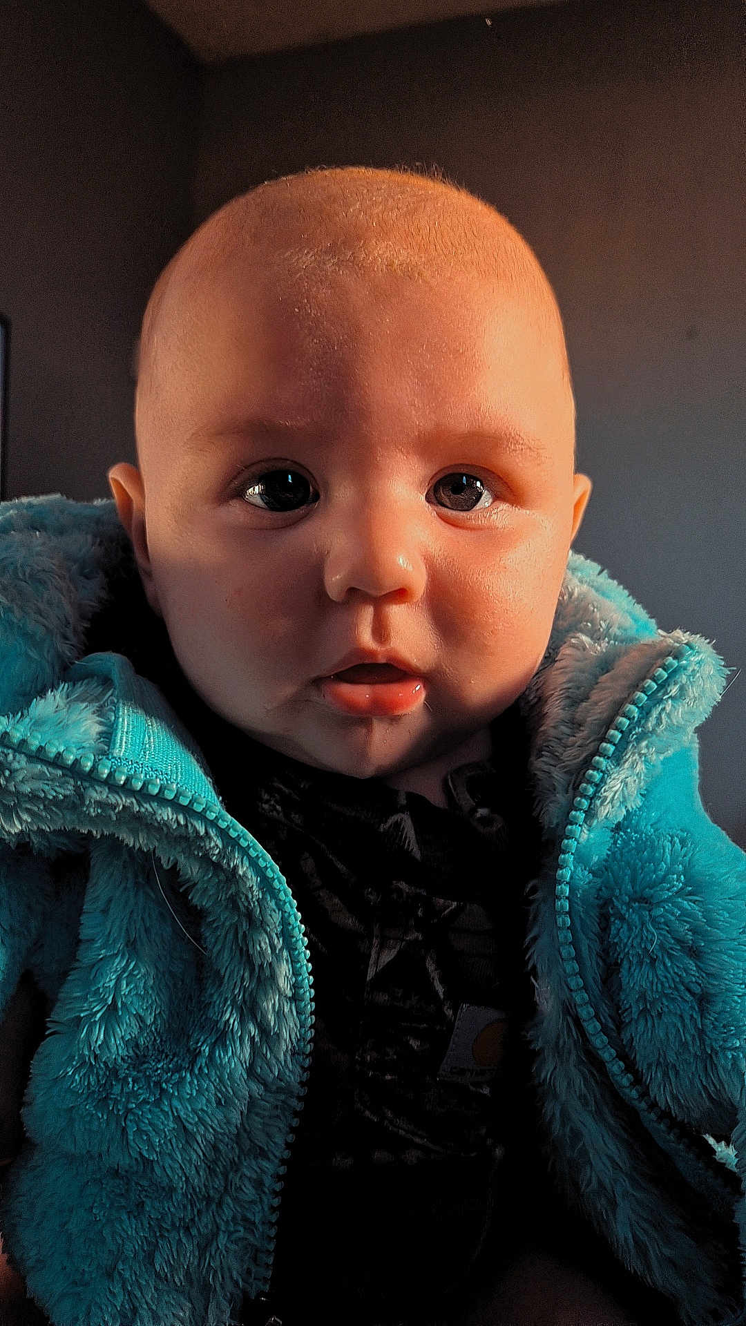Jayce is registered to the contest to win money with this photo: baby, child, face, eyes, jacket, clothing, drool, indoor, portrait, closeup, curious, cute, infant, young_child, soft_lighting, warm_colors, fuzzy_texture, person, head, expression