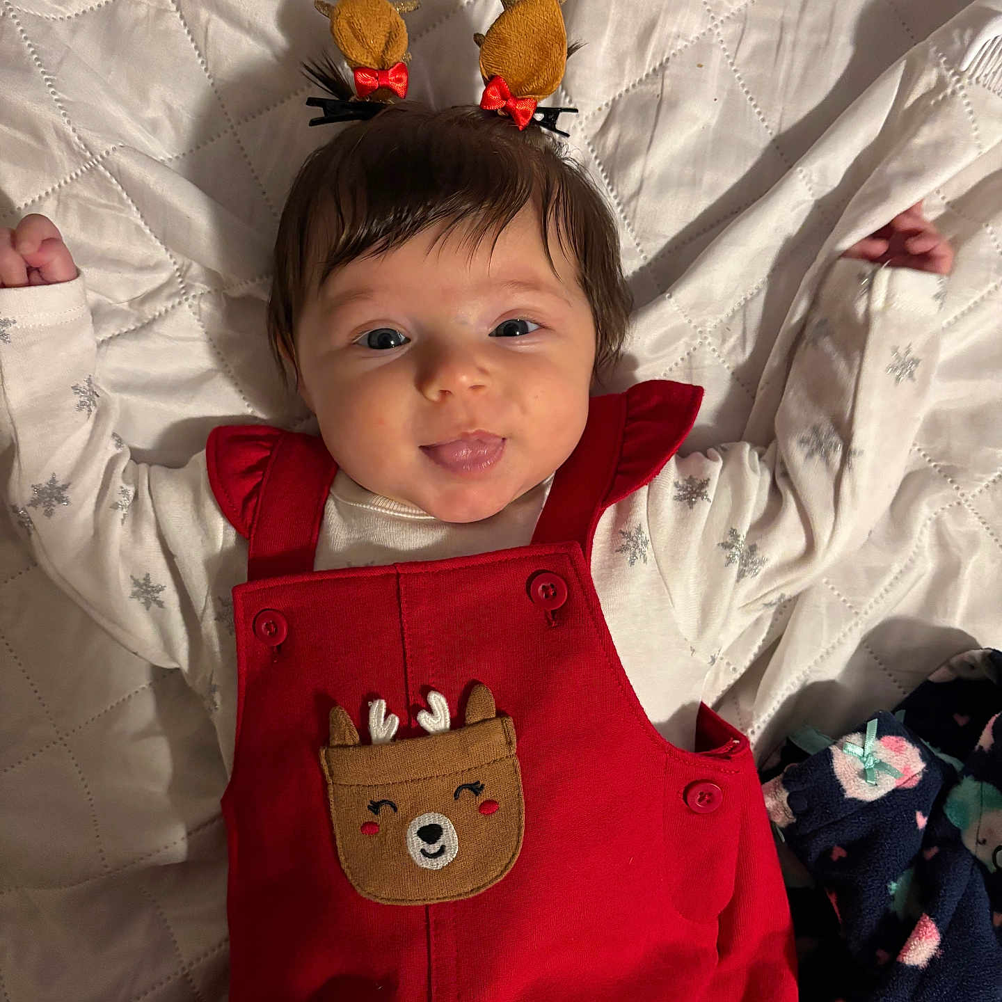 Kinsley is registered to the contest to win money with this photo: applique, baby, bodypart, clothing, coat, dress, face, finger, furniture, hand, happy, head, knitwear, pants, pattern, person, photography, portrait, smile, sweater