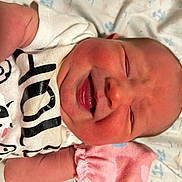 Gracelynn Ann Marie is registered to the contest to win money with this photo: baby, newborn, smiling, face, infant, clothing, pink_mittens, white_shirt, cow_print, lying_down, blanket, cute, joy, closeup, skin, head, person, sleepwear, peaceful, portrait