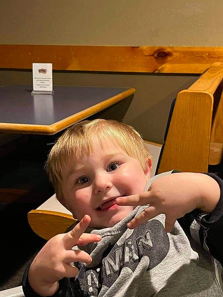 Derrick is registered to the contest to win money with this photo: baby, chair, child, flooring, fun, gesture, joy, nail, person, plywood, room, sitting, table, thumb, toddler, wood