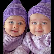 Arfa joined the competition — help win amazing prizes! baby, twin_babies, purple_hat, purple_sweater, smiling, cute, infant, knitwear, portrait, closeup, child, face, blue_eyes, soft_lighting, warm_clothing, adorable, happy, indoor, two_children, black_background