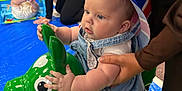 Isla-May joined the competition — help win amazing prizes! baby, child, infant, hat, colorful, inflatable_toy, green_toy, indoor, play_area, adult_hand, blue_mat, people, clothing, supporting_hand, face, cheeks, legs, eyes, toy, playtime