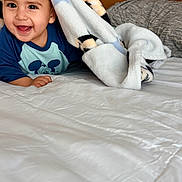 Maximiliano joined the competition — help win amazing prizes! baby, smiling, blanket, bed, mickey_mouse, child, happy, indoor, portrait, toddler, cute, clothing, person, face, head, playful, comfort, soft, home, cozy