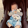 baby, car_seat, sleeping, plush_toy, mickey_mouse, blanket, denim, striped_clothing, socks, child, cute, infant, outdoor, soft_toy, nap, peaceful, small_hands, adorable, seat, comfort