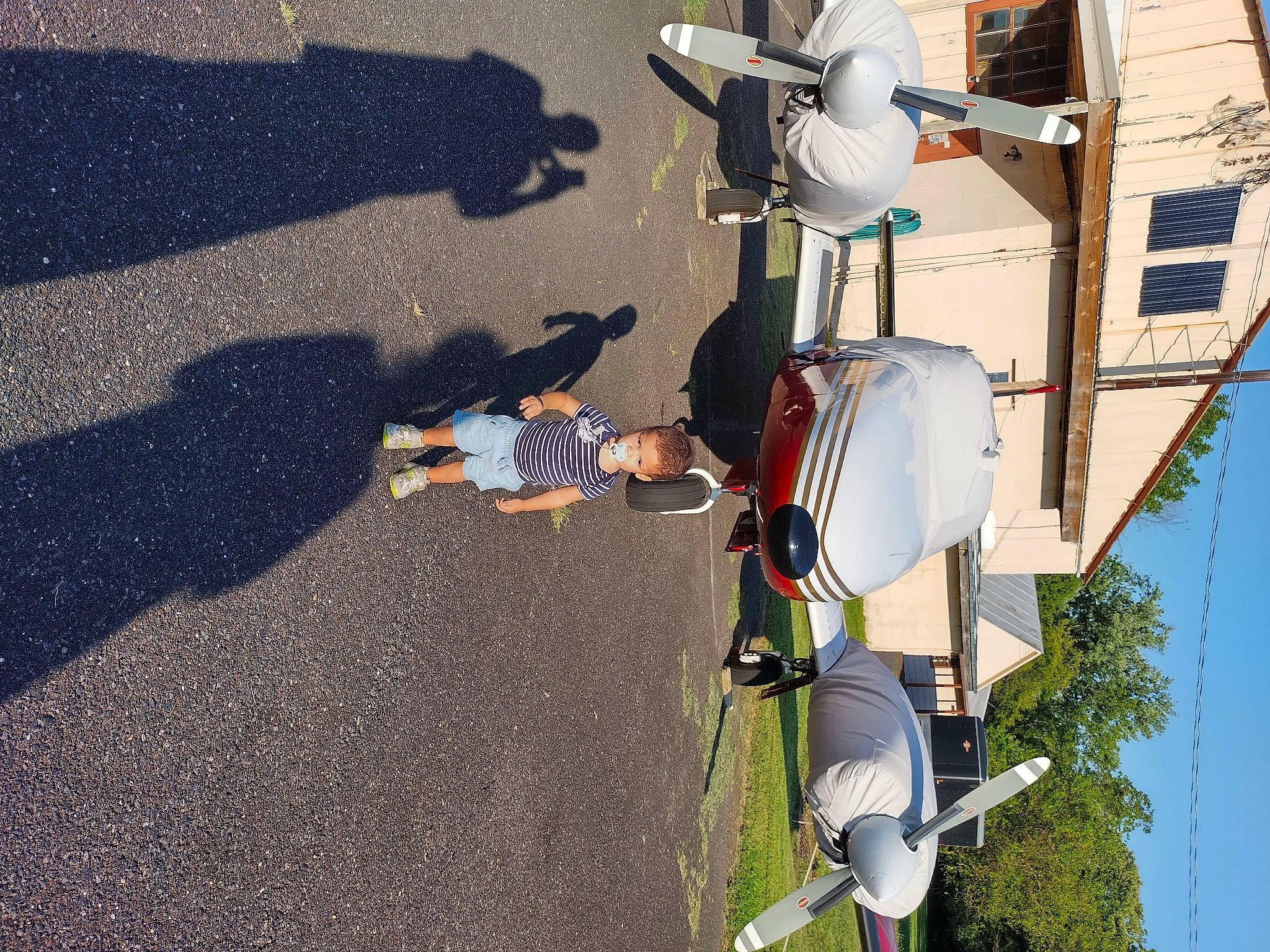 Kolten is registered to the contest to win money with this photo: asphalt, automotive_exterior, automotive_lighting, family_car, motor_vehicle, pedestrian, person, plant, pole, public_utility, road, road_surface, shadow, sidewalk, sky, street_light, tar, tree, vehicle, vehicle_door