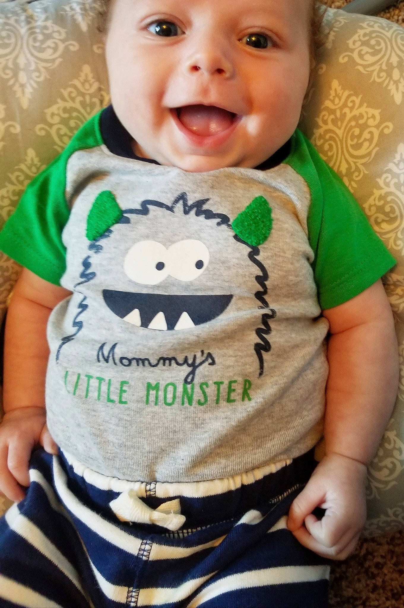 Ethan is registered to the contest to win money with this photo: baby, baby_products, baby_toddler_clothing, cheek, child, cool, facial_expression, green, happy, head, headwear, lip, pattern, person, product, sleeve, smile, t_shirt, toddler