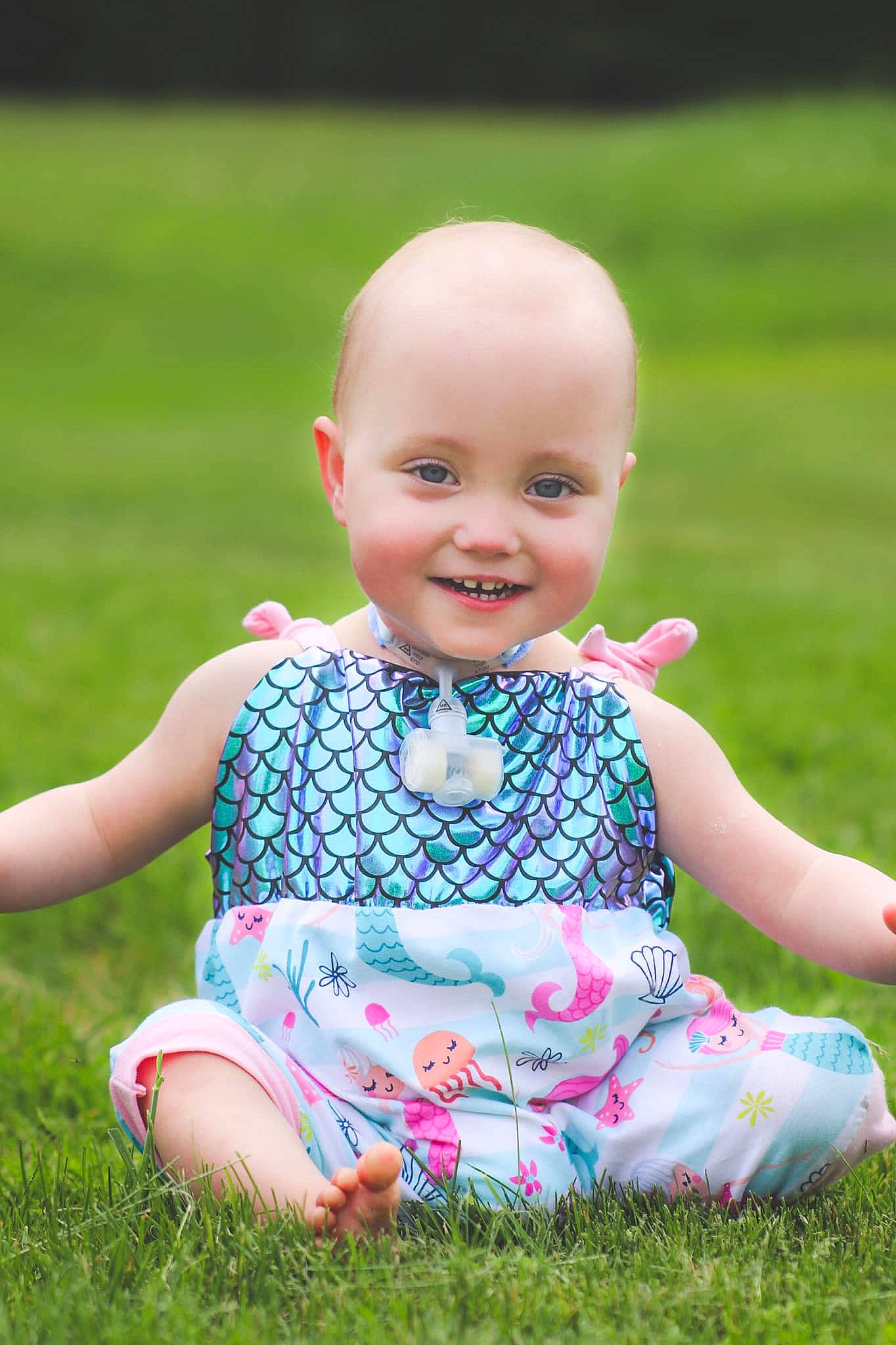 Aspen is registered to the contest to win money with this photo: baby, baby_toddler_clothing, child, dress, grass, grass_family, green, joy, lawn, meadow, pattern, people_in_nature, person, photography, pink, plant, sitting, skin, spring, summer