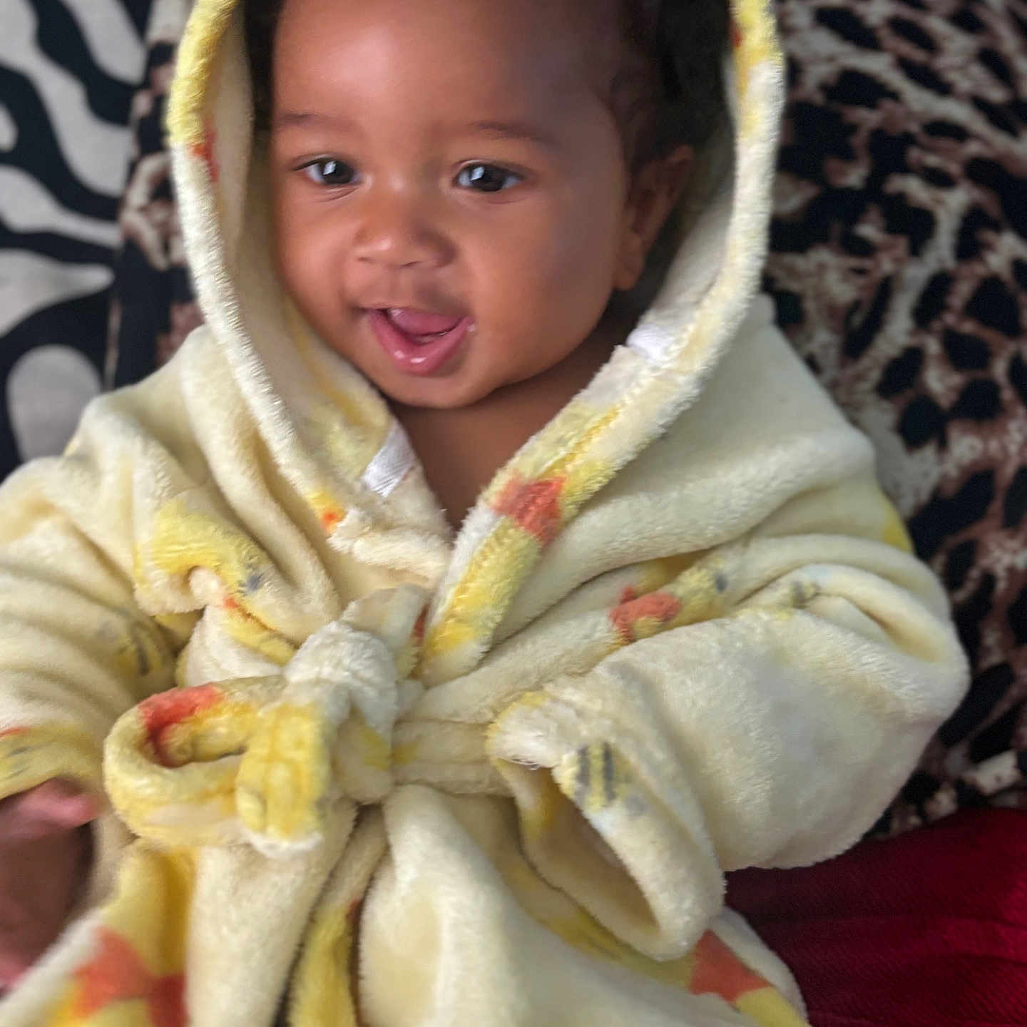 Kay Veon Boren joined the competition — help win amazing prizes! baby, child, smiling, hooded_robe, yellow_clothing, cute, portrait, indoor, face, person, soft_fabric, warm, happy, sitting, plush, infant, cozy, patterned_background, closeup, young