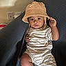 Kay Veon Boren is registered to the contest to win money with this photo: arm, baby, bucket_hat, child, clothing, couch, cozy, eyes, face, furniture, hand, home, indoors, infant, leg, photography, portrait, sitting, smiling, striped_outfit