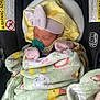 Raylynn is registered to the contest to win money with this photo: baby, newborn, sleeping, car_seat, blanket, pacifier, hat, pink, yellow, striped, cozy, infant, child, seatbelt, warning_label, soft, cute, resting, wrapped, indoors