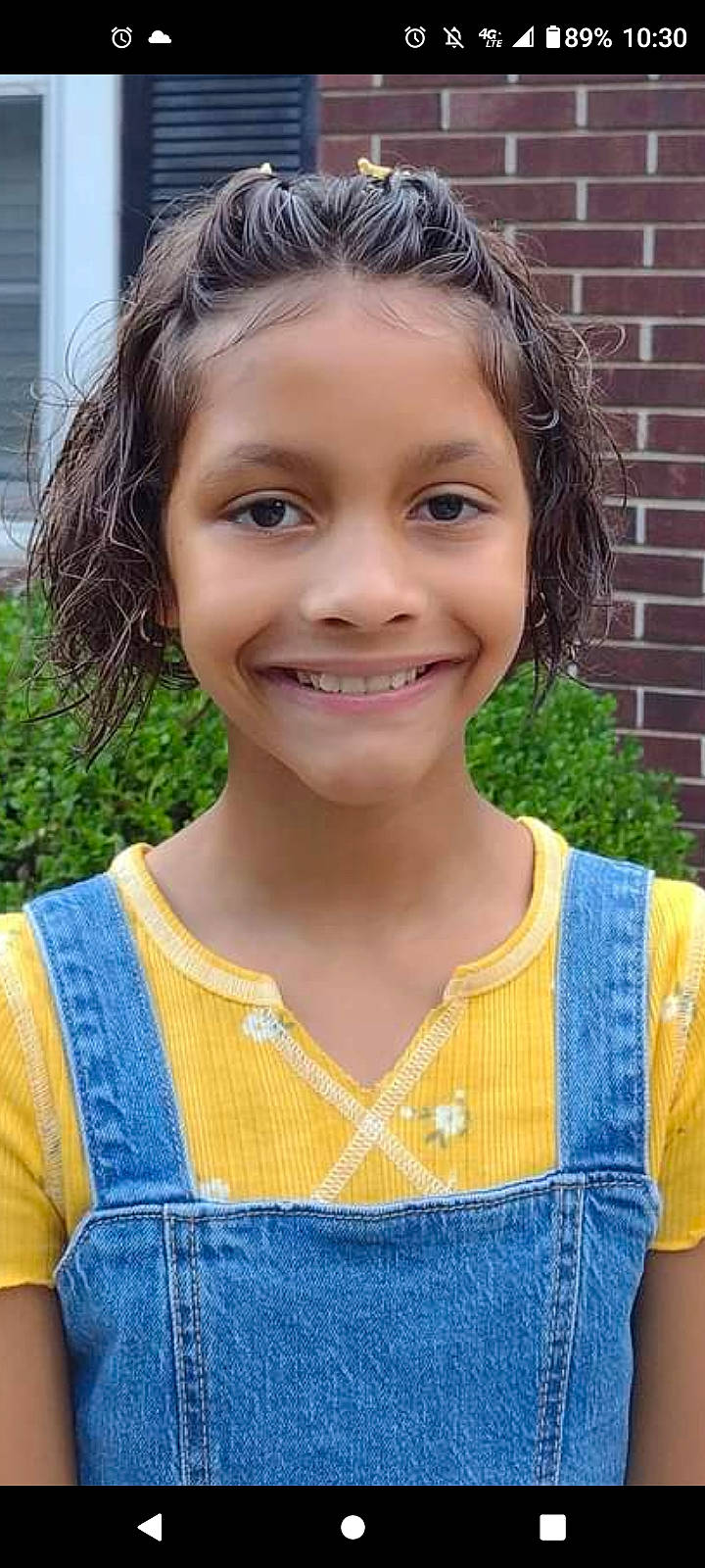 Jazlyn is registered to the contest to win money with this photo: brickwork, clothing, denim, electric_blue, eye, face, fashion_accessory, grass, hair, hairstyle, happy, head, jewellery, joy, neck, pattern, person, plant, sleeve, smile