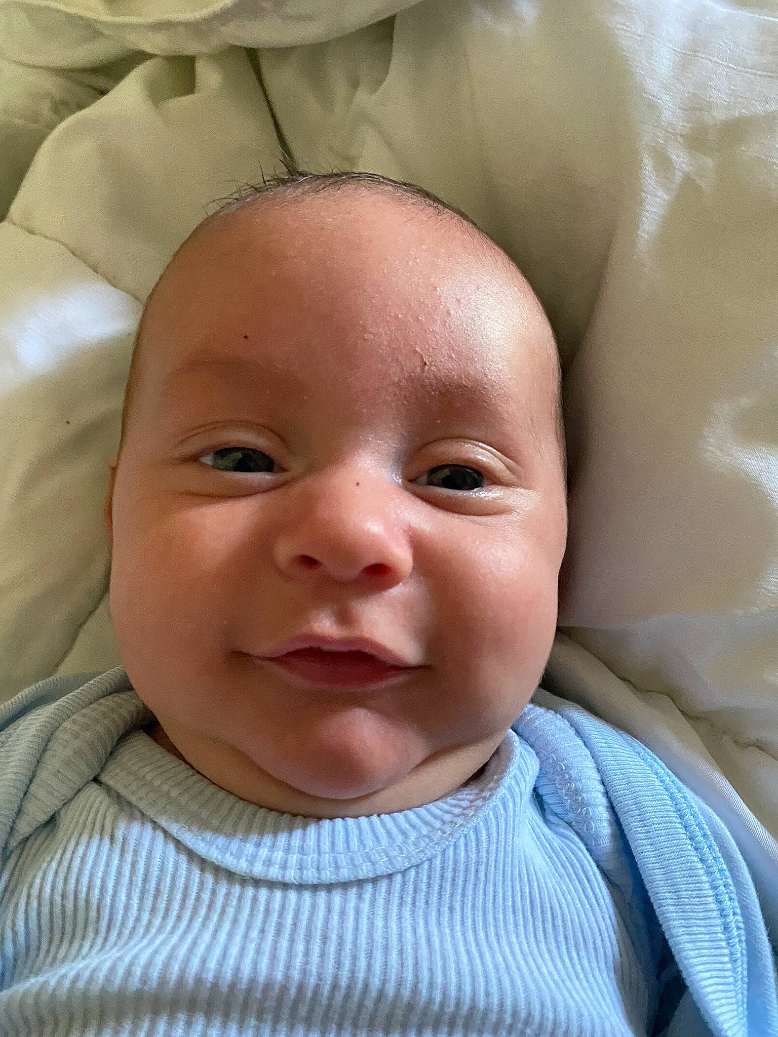 Owen is registered to the contest to win money with this photo: baby, baby_toddler_clothing, cheek, child, chin, comfort, eyebrow, eyelash, fun, happy, iris, linens, lip, mouth, nose, person, skin, smile, textile, toddler