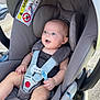 baby, car_seat, child, clothing, face, hand, happy, head, infant, outdoor, pacifier, person, restraint, safety, seat, seatbelt, smiling, straps, transport, warning_label