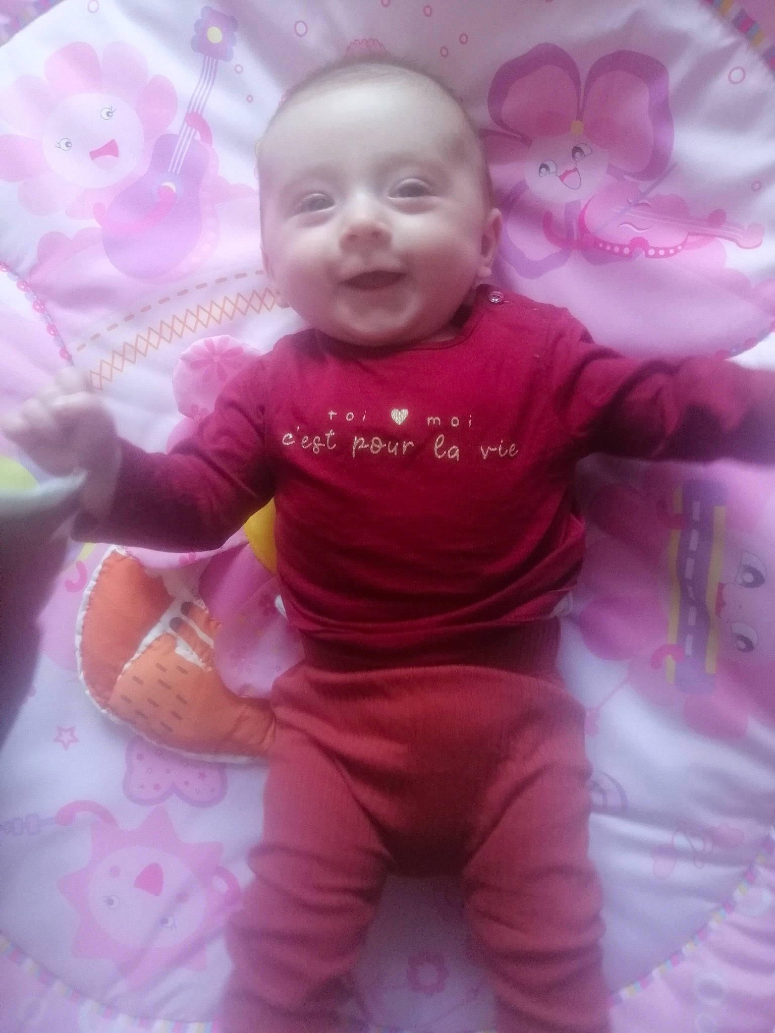 Ambre participe au concours pour gagner de l'argent avec cette photo : baby, baby_toddler_clothing, cheek, child, comfort, fun, happy, linens, lip, magenta, mouth, person, pink, purple, skin, sleeve, smile, textile, toddler, violet