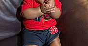 Asaiah joined the competition — help win amazing prizes! baby, black_shorts, bright_colors, child, clapping, couch, cute, hair, happy, indoor, infant, leather_couch, person, portrait, red_shirt, seated, skin, smiling, socks, striped_socks