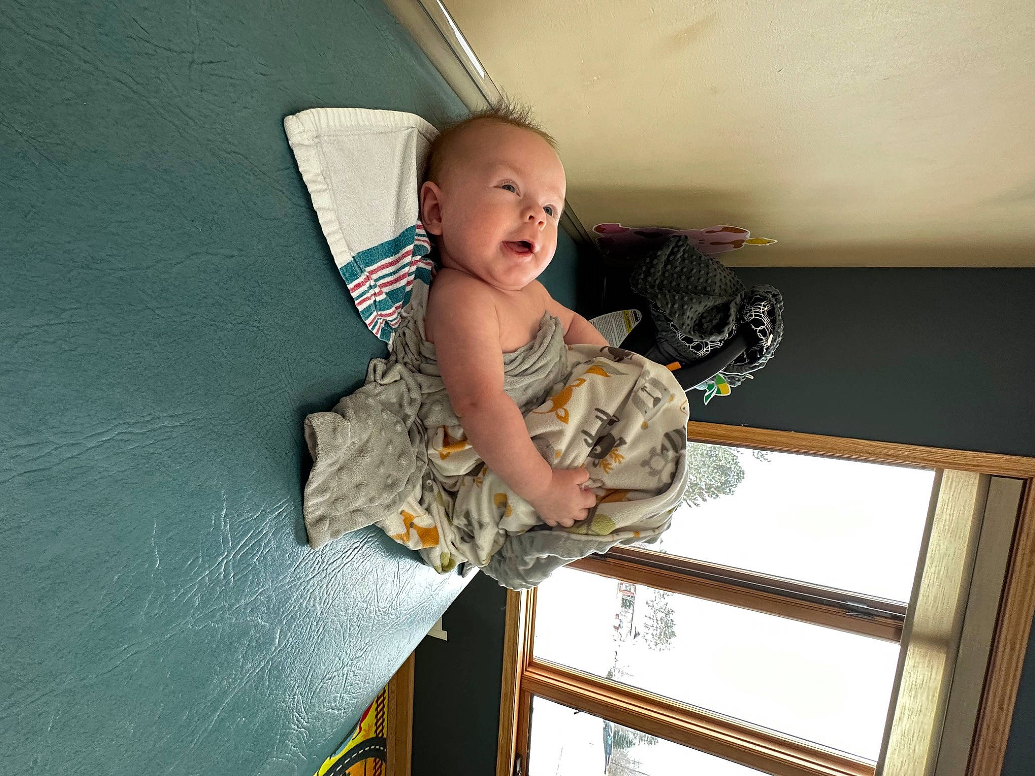 Forrest is registered to the contest to win money with this photo: baby, baby_toddler_clothing, ceiling, child, comfort, elbow, fashion_design, fun, happy, pattern, person, plaster, room, sitting, smile, thigh, toddler, wood
