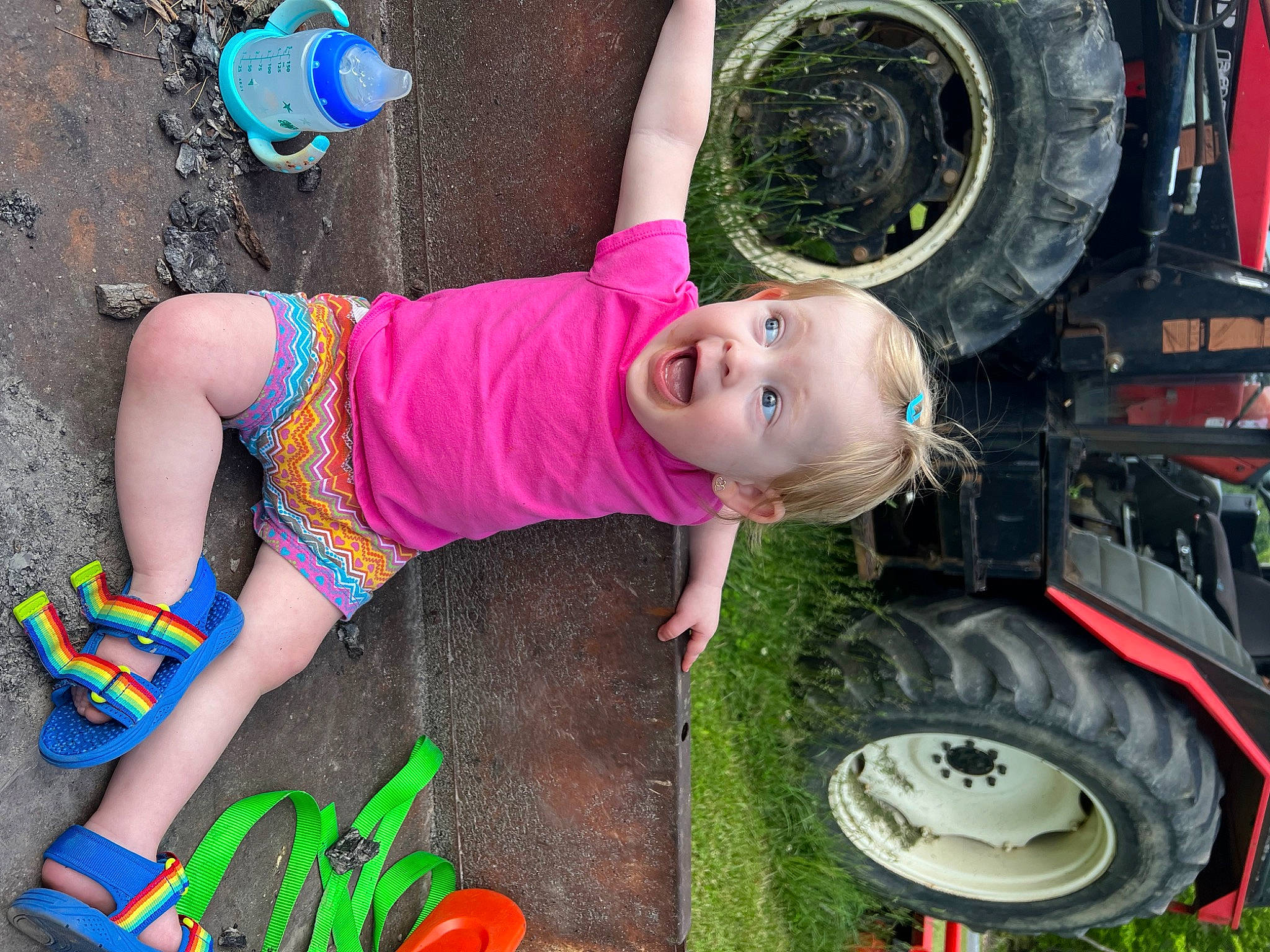 Gracelynn joined the competition — help win amazing prizes! automotive_exterior, automotive_tire, automotive_wheel_system, fender, grass, green, hat, motor_vehicle, person, plant, rim, surprise, synthetic_rubber, thigh, tire, tire_care, toddler, tread, tree, vehicle