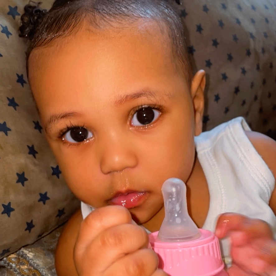 Keiasia is registered to the contest to win money with this photo: baby, beverage, bodypart, bottle, couch, cream, dessert, eating, face, finger, food, furniture, hand, happy, head, milk, person, photography, portrait, smile