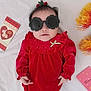 Eliana joined the competition — help win amazing prizes! baby, infant, child, sunglasses, red_dress, velvet, bow, hair_accessory, lying_down, white_sheet, greeting_card, envelope, decorative_flowers, hands, portrait, cute, fashion_accessory, smile, indoors, flatlay