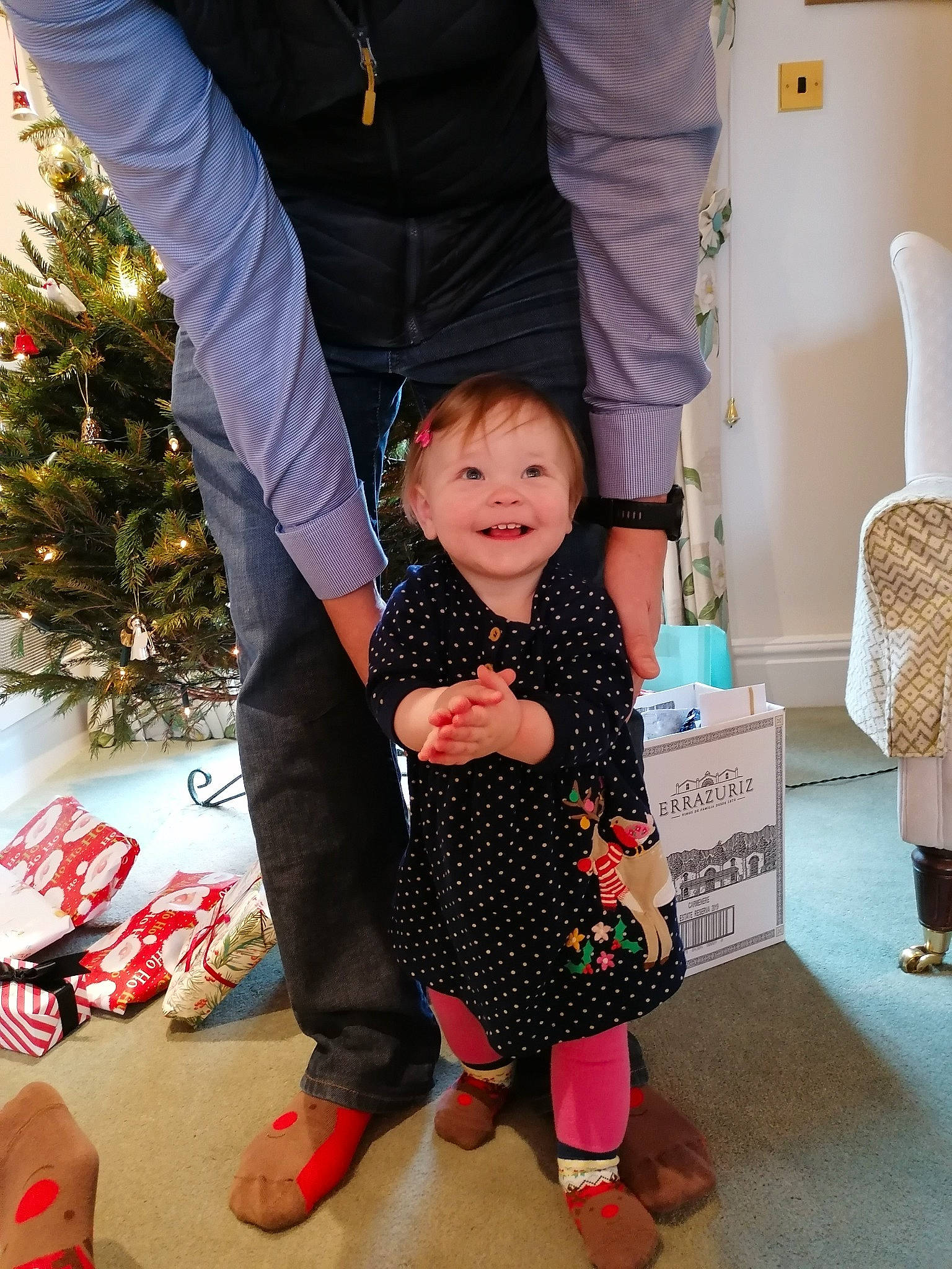 Freja is registered to the contest to win money with this photo: baby_toddler_clothing, christmas_tree, fashion, fun, gesture, hairstyle, hand, happy, head, human, human_body, joint, joy, leg, person, shoe, sleeve, sneakers, sock, standing