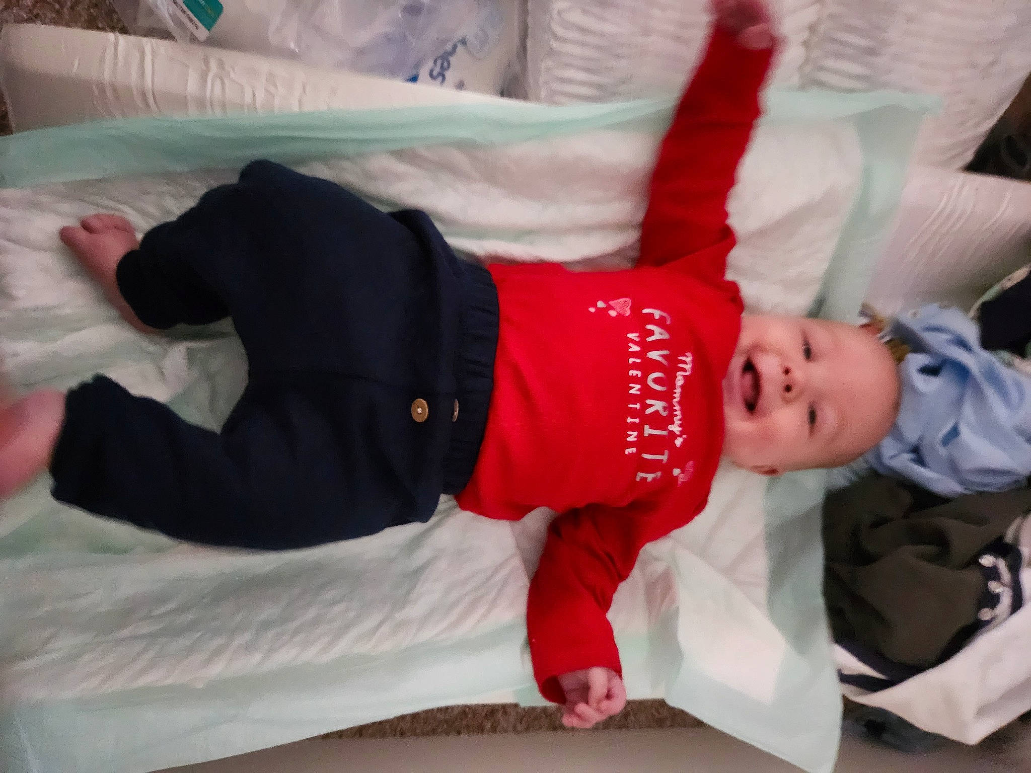 Zayden joined the competition — help win amazing prizes! baby, baby_toddler_clothing, carmine, child, comfort, elbow, flooring, foot, fun, happy, human_leg, knee, linens, person, room, sitting, sleeve, sock, t_shirt, thigh