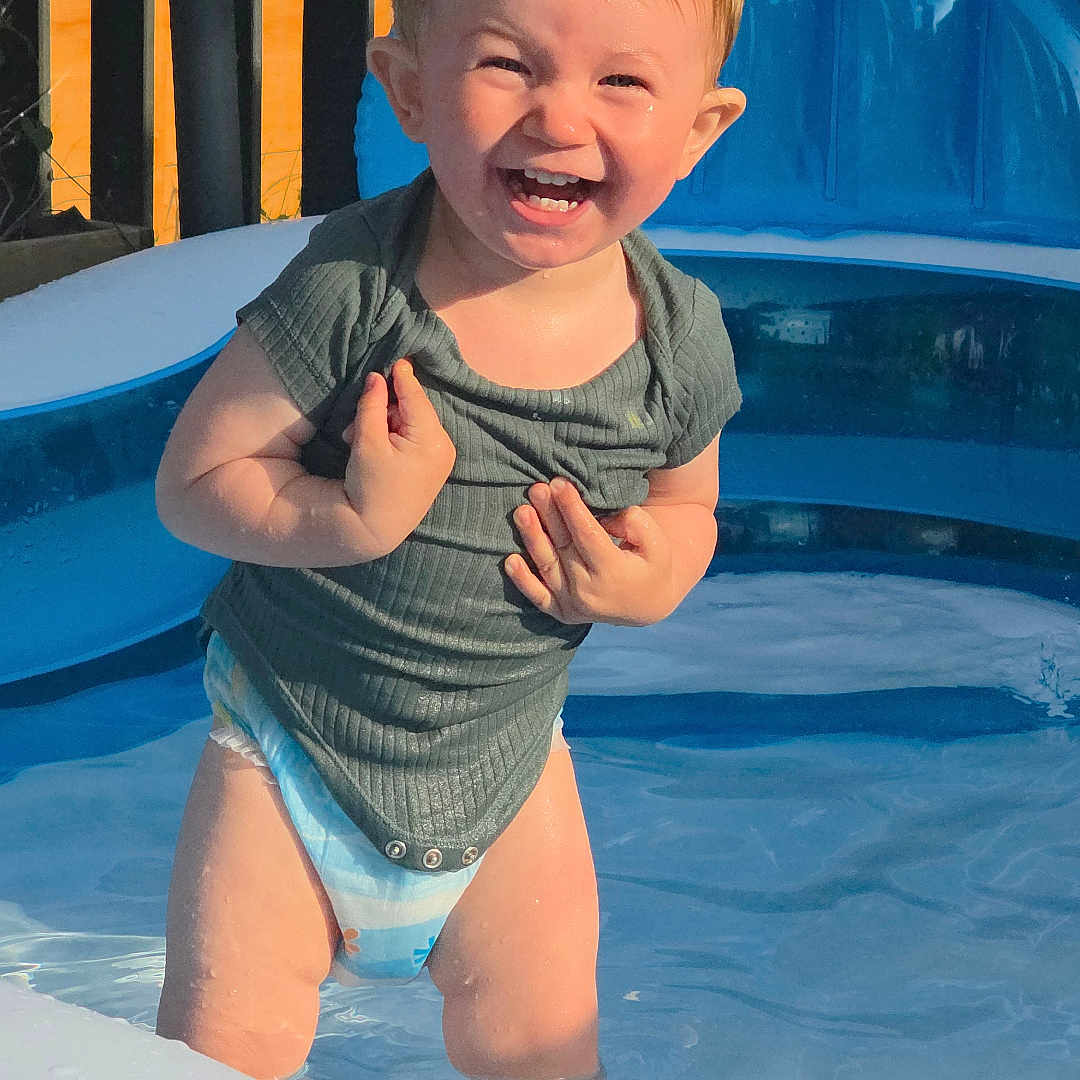 Oakley is registered to the contest to win money with this photo: backyard, child, cute, diaper, fun, happy, infant, joy, outdoor, play, pool, shirt, smile, splashing, summer, sunlight, toddler, warm, water, wet