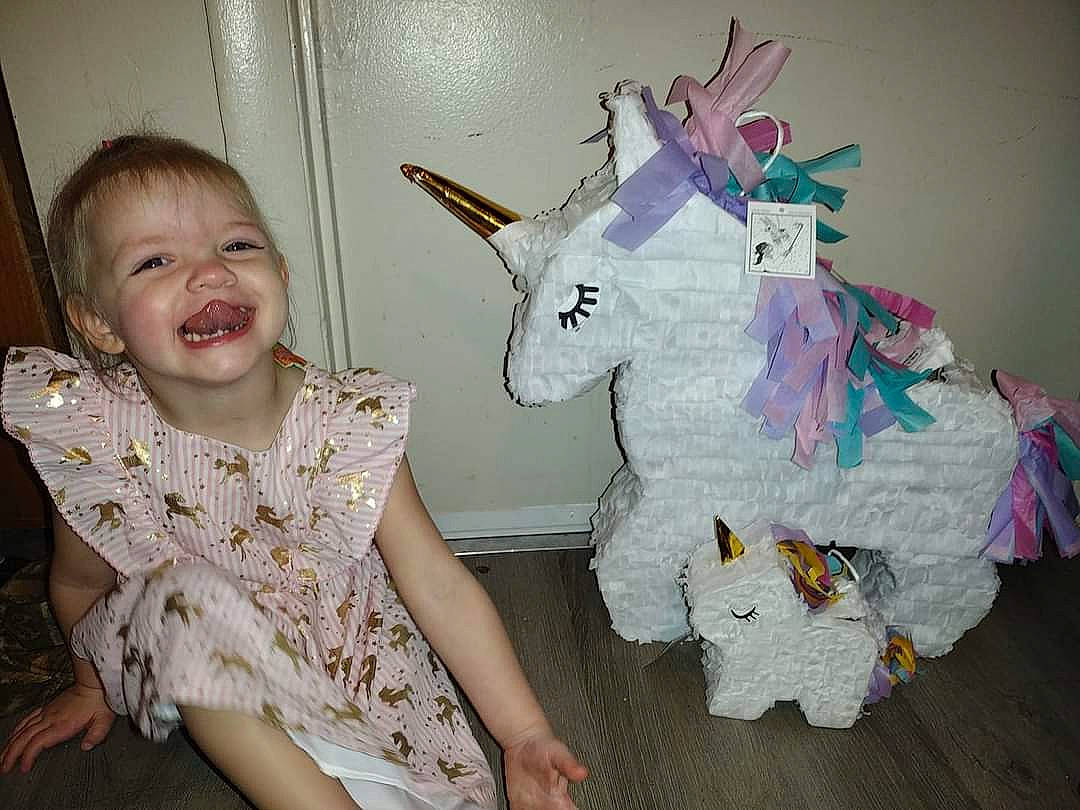 Grace joined the competition — help win amazing prizes! art, baby_toddler_clothing, child, creative_arts, event, face, fun, happy, joy, pattern, person, pinata, pink, product, purple, room, sleeve, smile, stuffed_toy, textile