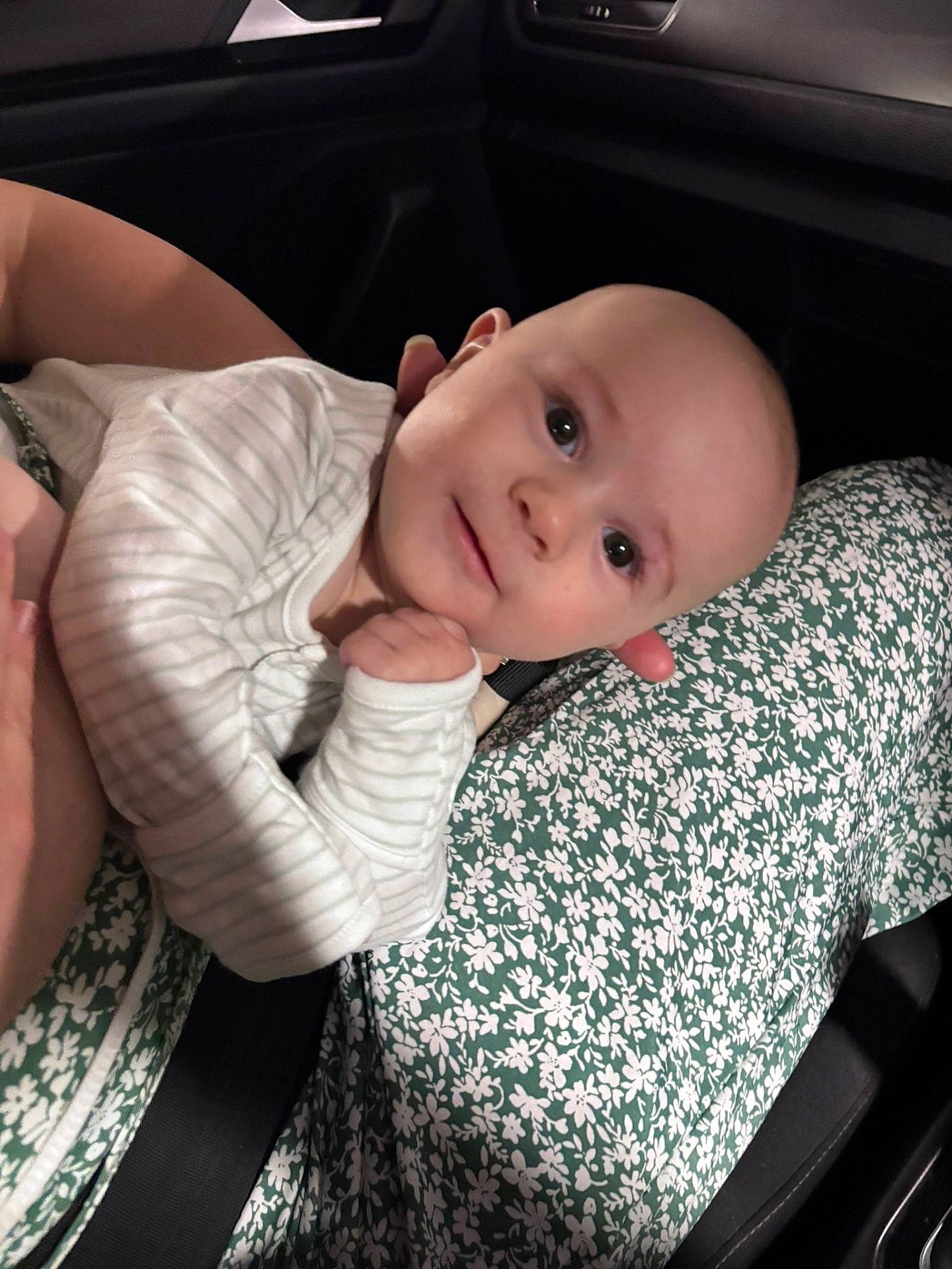 Ilario joined the competition — help win amazing prizes! baby, car_interior, child, closeup, comfort, cozy, cute, eyes, face, floral_pattern, hand, infant, person, portrait, seatbelt, sitting, smile, soft_lighting, striped_clothing, young