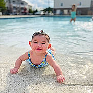 Scarlett joined the competition — help win amazing prizes! apartment_building, baby, background, child, daylight, fun, happy, outdoor, person, play, pool, recreation, smiling, splashing, summer, sunny, swimsuit, water, water_edge, young_child