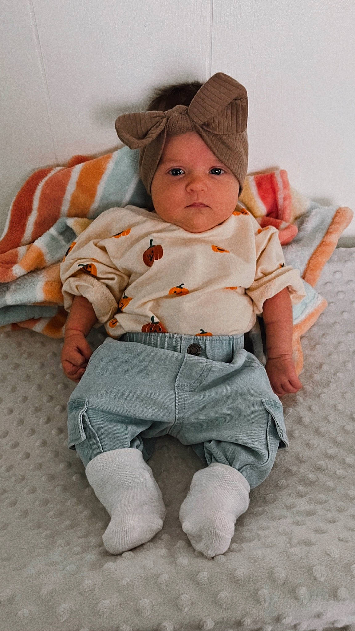 Sophie joined the competition — help win amazing prizes! baby, baby_products, baby_toddler_clothing, cap, cheek, child, collar, comfort, dress_shirt, eye, flooring, happy, linens, pattern, person, sitting, skin, sleeve, sock, textile