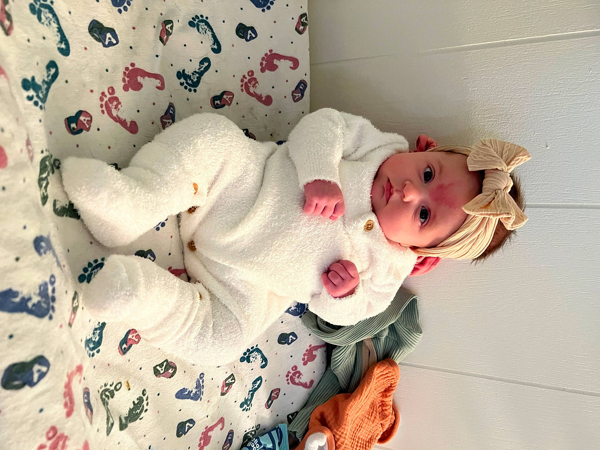 Sophie is registered to the contest to win money with this photo: baby, baby_products, baby_sleeping, baby_toddler_clothing, baby_toys, bed, carmine, child, comfort, dress, headwear, linens, pattern, person, petal, plant, room, rose, sleeve, stuffed_toy