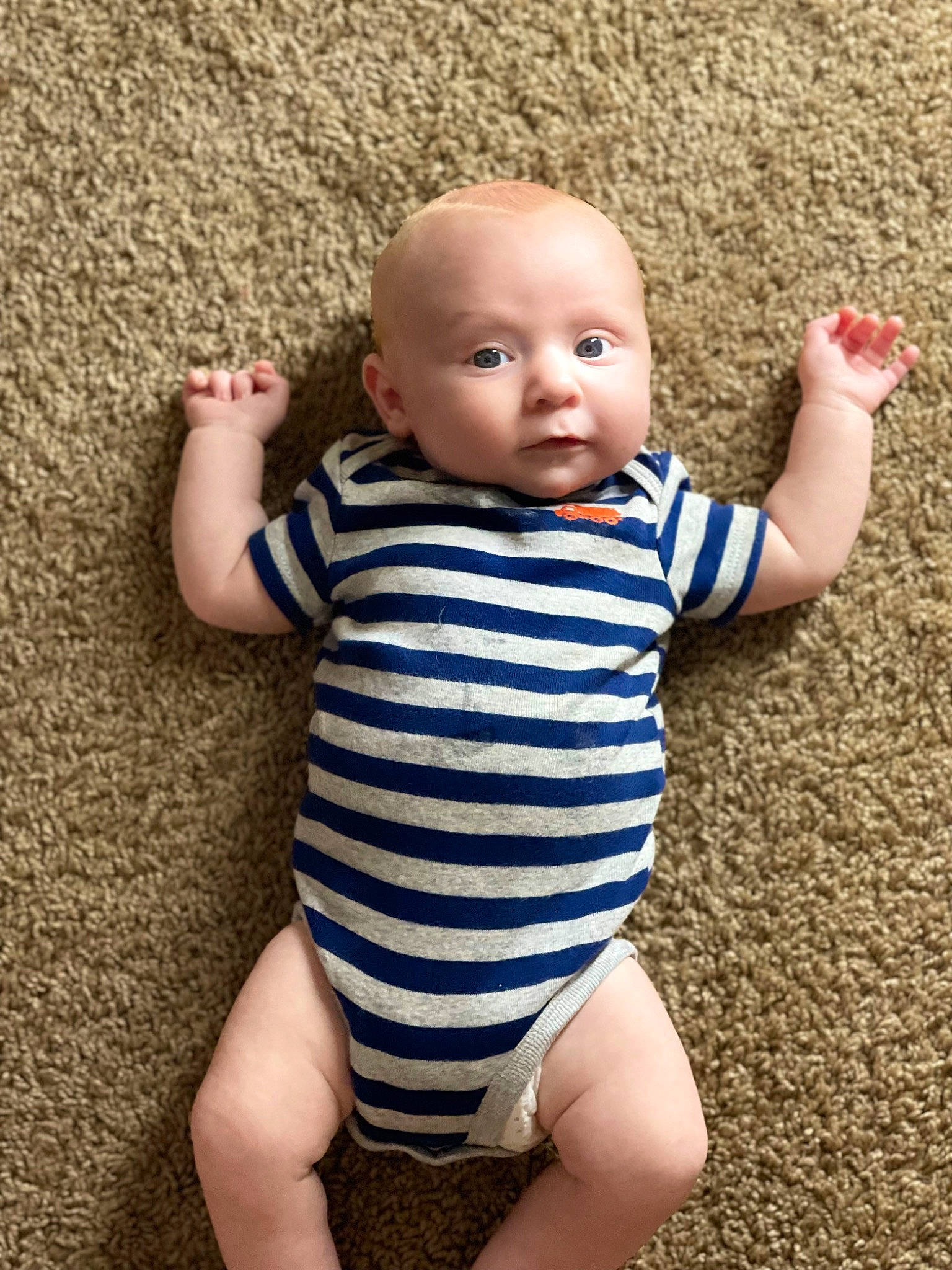 Brodie is registered to the contest to win money with this photo: baby, baby_toddler_clothing, cheek, elbow, eye, finger, gesture, happy, head, human_body, human_leg, infant_bodysuit, joint, leg, nail, person, skin, sleeve, thigh, thumb