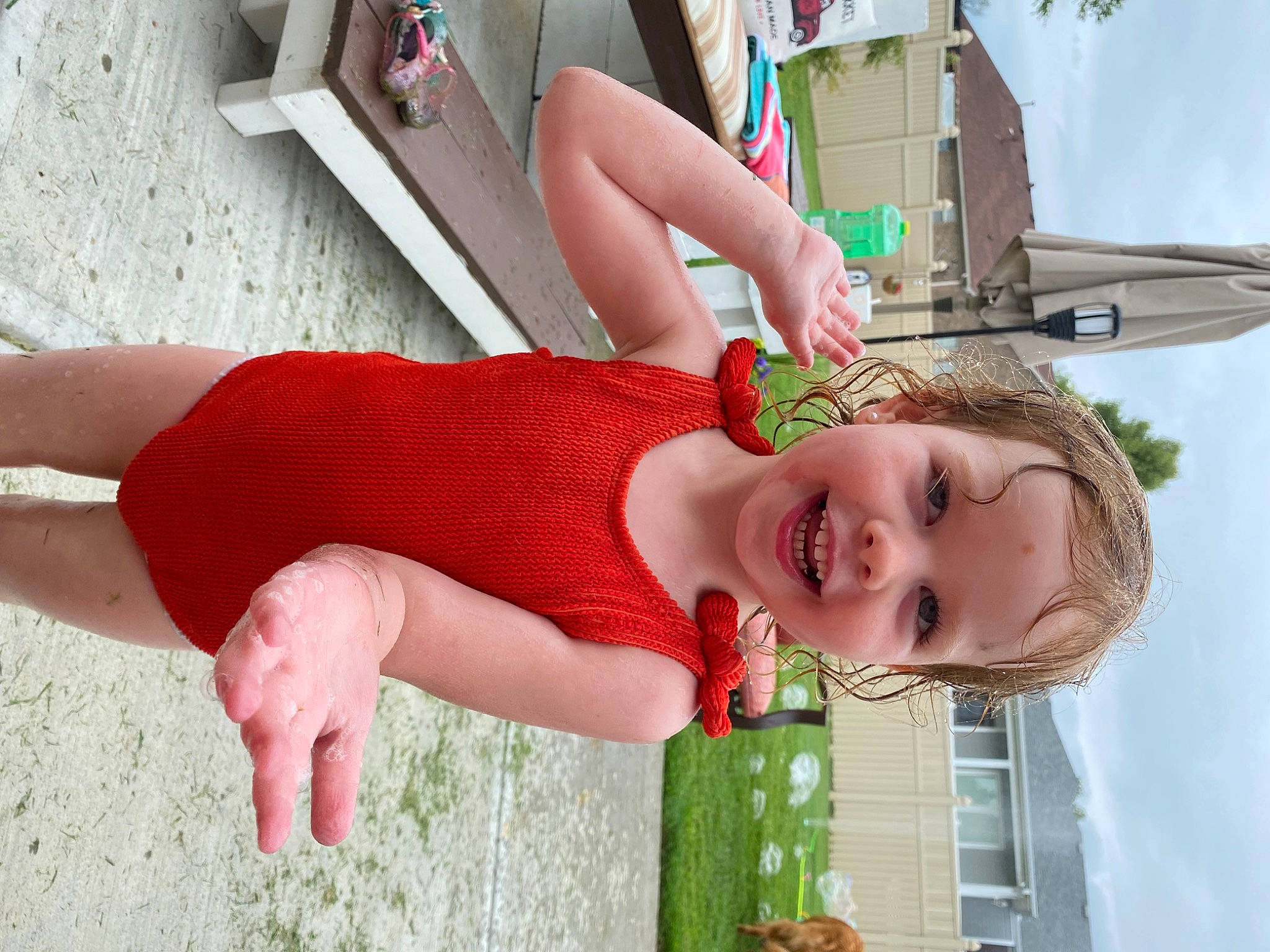 Josephine is registered to the contest to win money with this photo: child, foot, fun, grass, green, happy, human_leg, joy, knee, leg, leisure, neck, pattern, person, photograph, pink, play, sitting, skin, smile