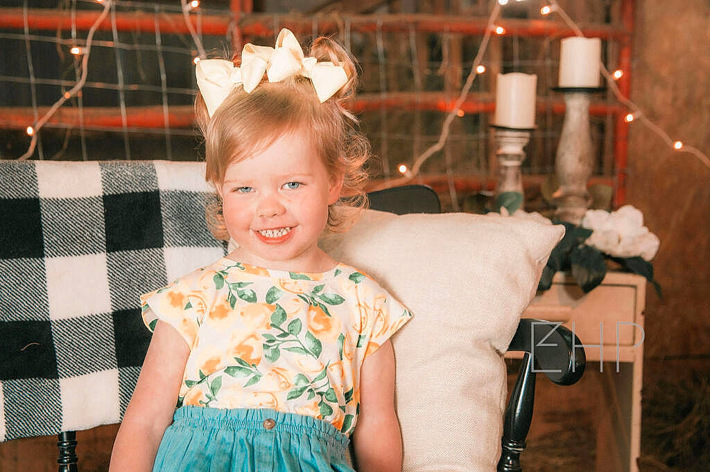 Josephine is registered to the contest to win money with this photo: baby_toddler_clothing, child, dress, event, face, facial_expression, flash_photography, formal_wear, fun, hairstyle, happy, iris, joy, pattern, person, pink, plaid, skin, smile, tartan